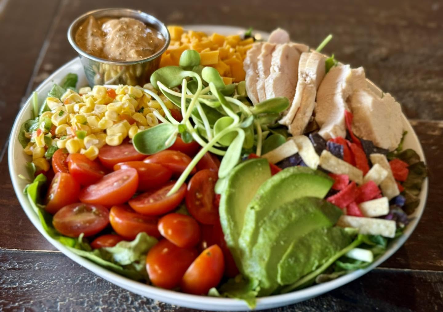 Cobb salad with chicken, avocado, corn salsa and tomatoes