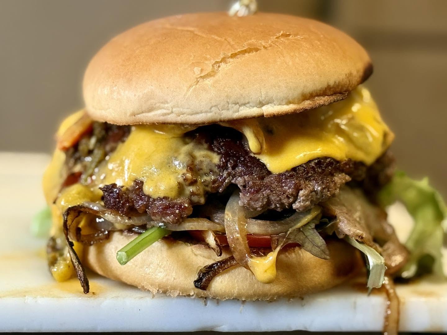 Double cheeseburger with grilled onions and lettuce